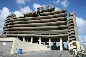 Multi-storey concrete car park with open parking decks and an exit lane