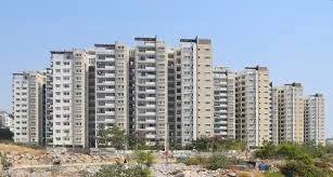 Cluster of multi-storey apartment towers seen from open ground