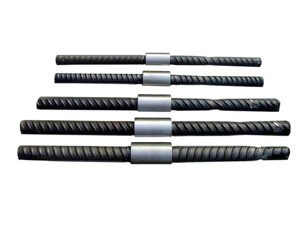 Five deformed rebars of increasing diameter, each pair joined mid-length by a steel coupler sleeve