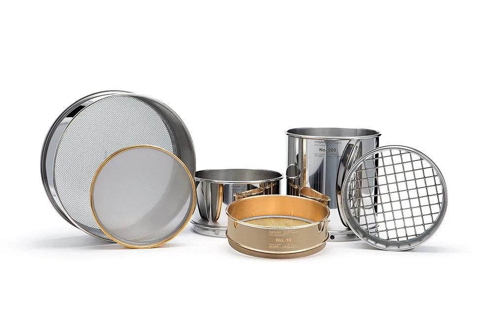 Assorted stainless steel and brass laboratory test sieves of different mesh sizes