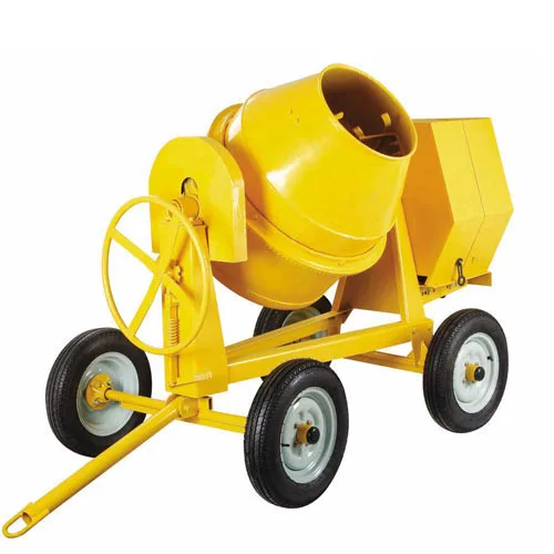 Yellow tilting drum concrete mixer on four wheels with a tow bar and a hand wheel for tilting the drum