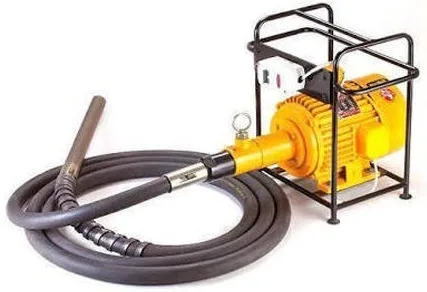 Needle vibrator: yellow electric motor in a tubular frame with a long flexible shaft and poker head